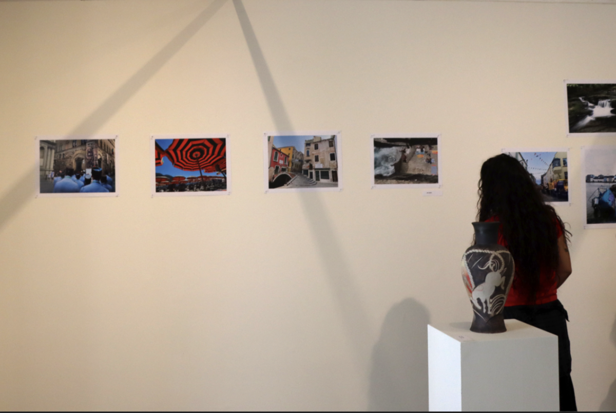 Visual arts teacher Talya Petrillo looks at artwork on display in the Eastern Star Gallery during the first show of the year. The exhibit, which features pieces made by faculty and staff, opened Sept. 11 during lunch.